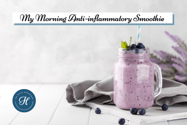 A purple smoothie in a mason jar mug sits on the kitchen cabinet with a straw, ready to drink - Recipe: My Anti-inflammatory Morning Smoothie - The Hacky Homemaker